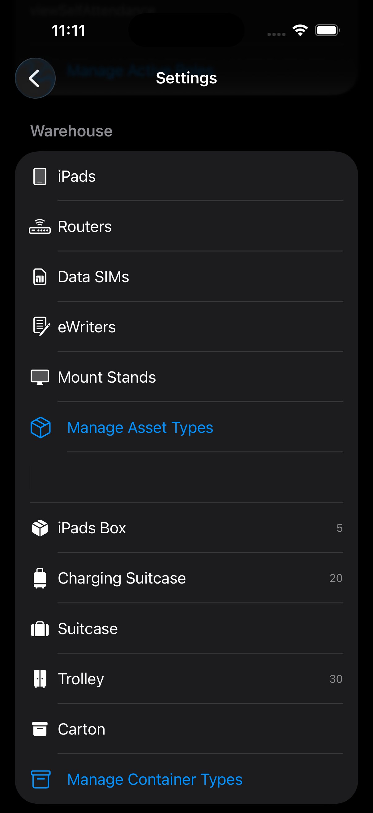 Warehouse settings list showing iPads, Routers, Data SIMs, eWriters, Mount Stands above a Manage Asset Types entry, then iPads Box, Charging Suitcase, Suitcase, Trolley, Carton, with capacity numbers, above a Manage Container Types entry